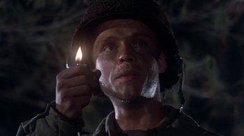 Movie still from “The Big Red One” (1980), directed by Samuel Fuller – A man holding a lit candle in his hand; Close Up shot, Low angle