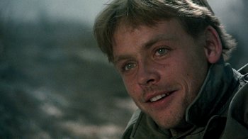 Movie still from “The Big Red One” (1980), directed by Samuel Fuller – A man's face with a mountain in the background; Close Up shot, Over the shoulder angle