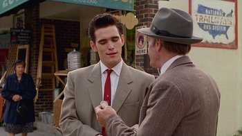 Movie still from “The Big Town” (1987), directed by Harold Becker – A man wearing a suit and tie talking to another man wearing a hat; Medium shot, Over the shoulder angle