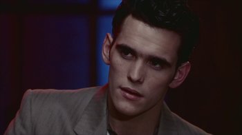 Movie still from “The Big Town” (1987), directed by Harold Becker – A person wearing a suit; Close Up shot, Over the shoulder angle