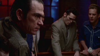 Movie still from “The Big Town” (1987), directed by Harold Becker – Two men in suits are sitting in a courtroom; Close Up shot, Over the shoulder angle