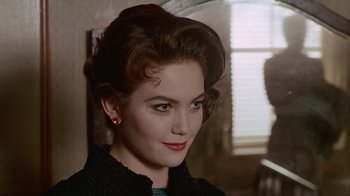 Movie still from “The Big Town” (1987), directed by Harold Becker – A person wearing a black jacket; Close Up shot, Over the shoulder angle