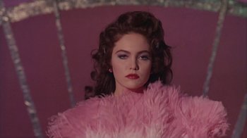 Movie still from “The Big Town” (1987), directed by Harold Becker – A person wearing a pink dress; Medium shot, Low angle