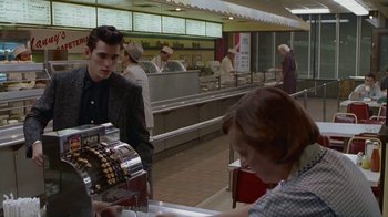 Movie still from “The Big Town” (1987), directed by Harold Becker – A man and a woman are waiting for their order at a diner; Medium shot, Over the shoulder angle