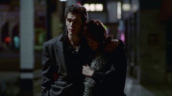 Movie still from “The Big Town” (1987), directed by Harold Becker – A man and a woman standing next to each other on the street; Medium shot, Low angle