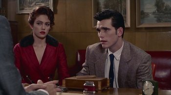 Movie still from “The Big Town” (1987), directed by Harold Becker – A man and a woman sitting at a table in front of each other; Medium shot, Over the shoulder angle