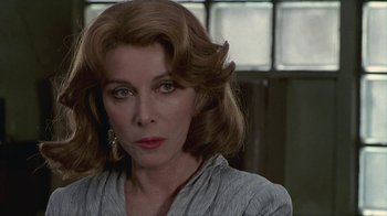 Movie still from “The Big Town” (1987), directed by Harold Becker – A person wearing a gray shirt; Close Up shot, Over the shoulder angle