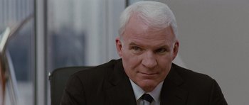 Movie still from “The Big Year” (2011), directed by David Frankel – An older man in a suit and tie looking at the camera; Close Up shot, Over the shoulder angle