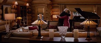 Movie still from “The Big Year” (2011), directed by David Frankel – A man and a woman hugging in a living room; Wide shot, Over the shoulder angle