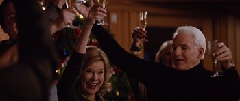 Movie still from “The Big Year” (2011), directed by David Frankel – A group of people raising their glasses in the air; Medium shot, Low angle