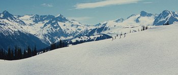 Movie still from “The Big Year” (2011), directed by David Frankel – A group of skiers skiing down a snowy slope; Extreme Wide shot, High angle