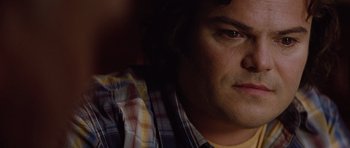 Movie still from “The Big Year” (2011), directed by David Frankel – A man's face in a plaid shirt; Close Up shot, Over the shoulder angle