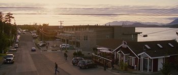 Movie still from “The Big Year” (2011), directed by David Frankel – People are walking down the street in front of a building; Extreme Wide shot, Low angle