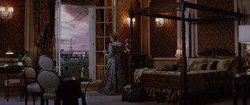 Movie still from “The Big Year” (2011), directed by David Frankel – A woman standing in front of an open door in a room; Wide shot, Over the shoulder angle