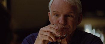 Movie still from “The Big Year” (2011), directed by David Frankel – A person holding a glass of wine; Close Up shot, Over the shoulder angle
