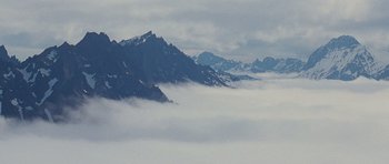 Movie still from “The Big Year” (2011), directed by David Frankel – A view of a mountain range in the clouds; Extreme Wide shot, High angle