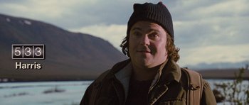 Movie still from “The Big Year” (2011), directed by David Frankel – A person wearing a jacket and a hat; Close Up shot, Over the shoulder angle