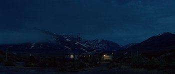Movie still from “The Big Year” (2011), directed by David Frankel – A house in the middle of a field at night with mountains in the background; Extreme Wide shot, Low angle