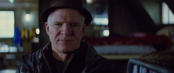 Movie still from “The Big Year” (2011), directed by David Frankel – A person wearing a hat and a jacket; Close Up shot, Low angle