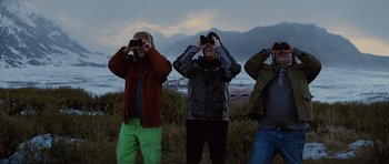 Movie still from “The Big Year” (2011), directed by David Frankel – A group of people standing next to each other looking through binoculars; Medium shot, Low angle