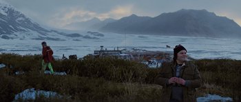 Movie still from “The Big Year” (2011), directed by David Frankel – A man standing on top of a grass covered field; Wide shot, Low angle