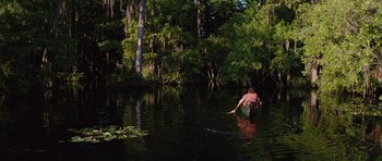 Movie still from “The Big Year” (2011), directed by David Frankel – A person in a canoe paddling through the water; Extreme Wide shot, High angle
