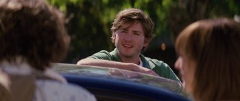 Movie still from “The Big Year” (2011), directed by David Frankel – A man sitting in the back seat of a car; Close Up shot, Over the shoulder angle