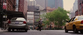 Movie still from “The Big Year” (2011), directed by David Frankel – An older man walking down the street in a city; Wide shot, Over the shoulder angle