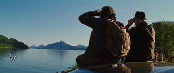 Movie still from “The Big Year” (2011), directed by David Frankel – A man sitting on top of a boat on the water; Wide shot, Low angle