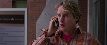 Movie still from “The Big Year” (2011), directed by David Frankel – A man talking on a cell phone while wearing a plaid shirt; Close Up shot, Low angle