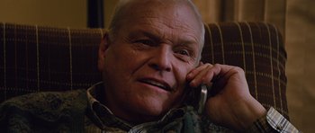 Movie still from “The Big Year” (2011), directed by David Frankel – An older man talking on a cell phone while sitting in a chair; Close Up shot, Low angle