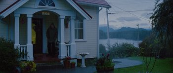 Movie still from “The Big Year” (2011), directed by David Frankel – A woman standing on the porch of a house; Wide shot, Over the shoulder angle