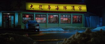 Movie still from “The Big Year” (2011), directed by David Frankel – A car parked in front of an asian restaurant at night; Extreme Wide shot, High angle