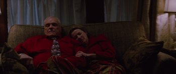 Movie still from “The Big Year” (2011), directed by David Frankel – An older man and a woman snuggling on a couch; Medium shot, High angle