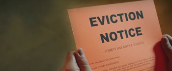 Movie still from “The Biggest Little Farm” (2018), directed by John Chester – A person holding a eviction notice in their hand; Extreme Close Up shot, High angle