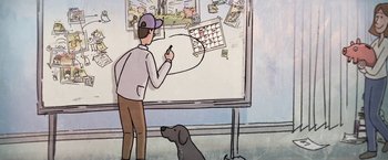 Movie still from “The Biggest Little Farm” (2018), directed by John Chester – A man standing in front of a whiteboard writing on a calendar; Wide shot, Over the shoulder angle