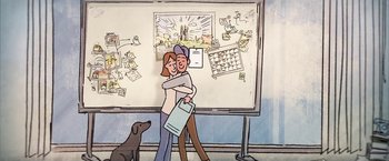 Movie still from “The Biggest Little Farm” (2018), directed by John Chester – Two people hug in front of a whiteboard; Wide shot, High angle