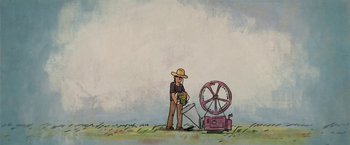 Movie still from “The Biggest Little Farm” (2018), directed by John Chester – A man standing in front of an old fashioned water pump; Wide shot, Low angle
