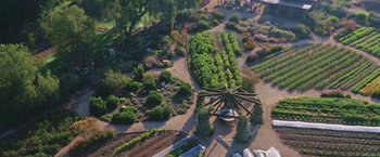 Movie still from “The Biggest Little Farm” (2018), directed by John Chester – An aerial view of a garden with a gazebo in the center; Extreme Wide shot, Overhead angle