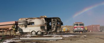 Movie still from “The Biggest Little Farm” (2018), directed by John Chester – An rv that has been destroyed in the middle of a field; Extreme Wide shot, Low angle
