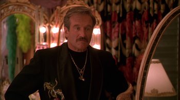 Movie still from “The Birdcage” (1996), directed by Mike Nichols – A person wearing a suit and tie; Close Up shot, Over the shoulder angle