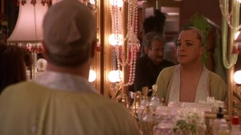 Movie still from “The Birdcage” (1996), directed by Mike Nichols – A man and a woman looking in a mirror; Medium shot, Over the shoulder angle