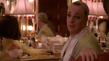 Movie still from “The Birdcage” (1996), directed by Mike Nichols – A man sitting in front of a mirror in front of a table; Close Up shot, Over the shoulder angle