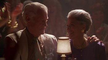 Movie still from “The Birdcage” (1996), directed by Mike Nichols – An older man and a younger woman smile at each other; Close Up shot, Low angle
