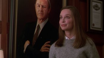 Movie still from “The Birdcage” (1996), directed by Mike Nichols – A woman standing in front of a painting of a man; Close Up shot, Low angle
