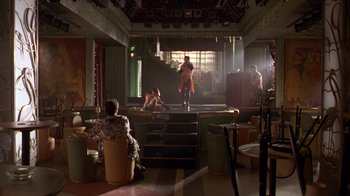 Movie still from “The Birdcage” (1996), directed by Mike Nichols – People are sitting and standing in a room; Wide shot, Low angle
