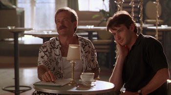 Movie still from “The Birdcage” (1996), directed by Mike Nichols – Two men sitting at a table in a restaurant; Medium shot, Over the shoulder angle