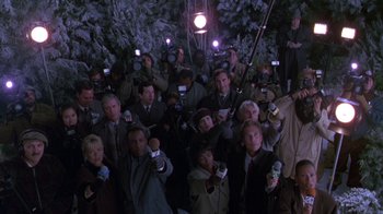 Movie still from “The Birdcage” (1996), directed by Mike Nichols – A large group of people holding microphones in their hands; Wide shot, High angle