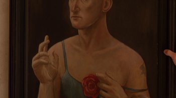 Movie still from “The Birdcage” (1996), directed by Mike Nichols – A painting of a man holding a red rose in front of his chest; Close Up shot, High angle