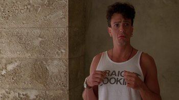 Movie still from “The Birdcage” (1996), directed by Mike Nichols – A man in a white shirt is looking at the camera; Close Up shot, Over the shoulder angle